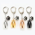 Pet memorial urn keychain with paw charm in silver, gold, rose gold, and black