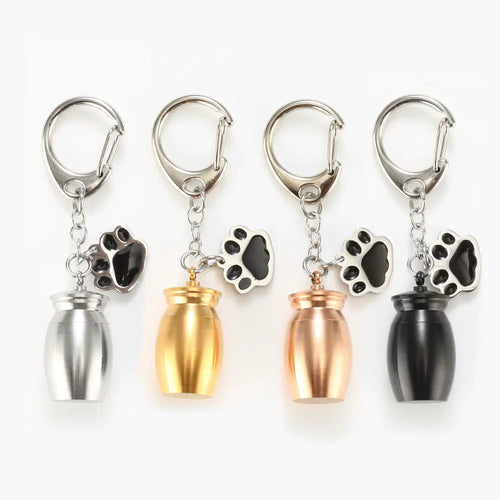 Pet memorial urn keychain with paw charm in silver, gold, rose gold, and black